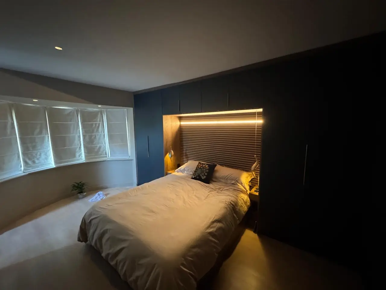 Bedroom navy fitted wardrobe bay window view, made and fitted by Sussex Design Interiors
