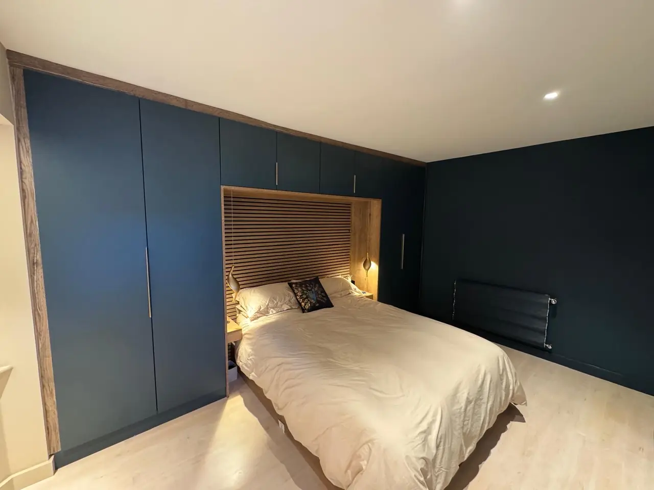 Bedroom navy fitted wardrobe oak headboard nook, made and fitted by Sussex Design Interiors