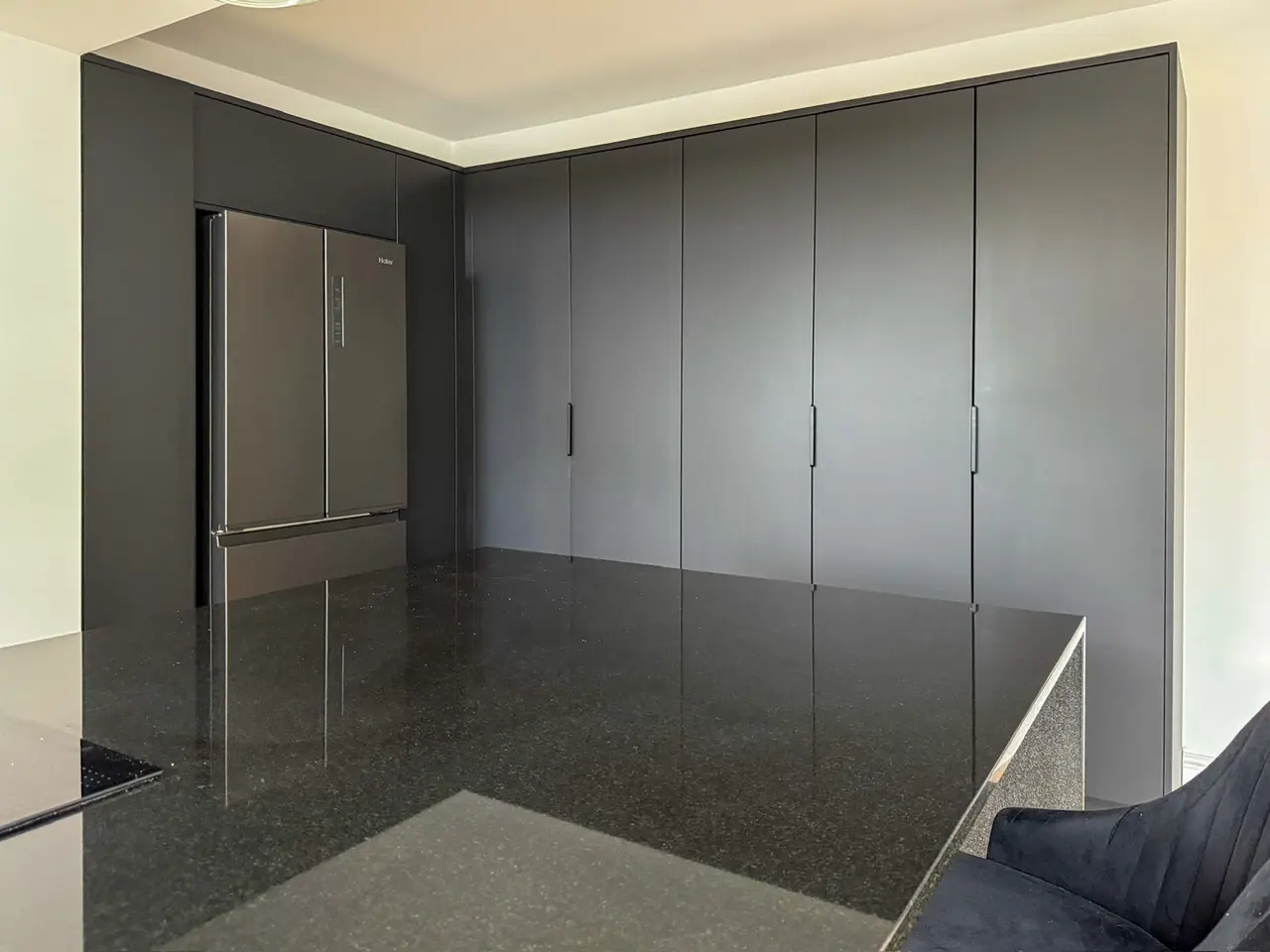 Full-height anthracite tall units with an integrated fridge freezer, made and fitted by Sussex Design Interiors