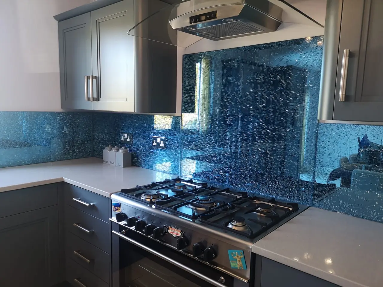 Kitchen blue glass splashback range cooker, made and fitted by Sussex Design Interiors