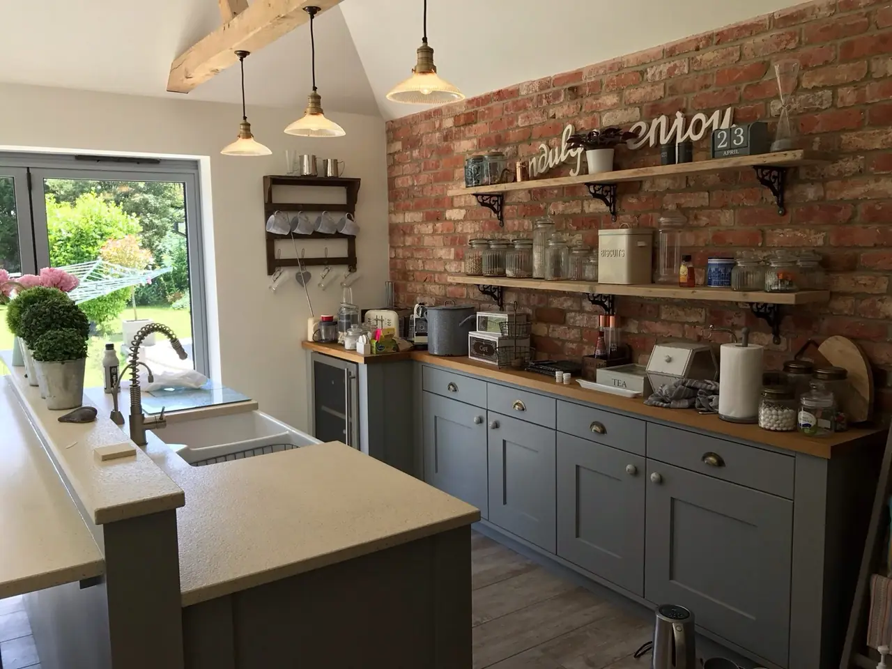 Kitchen brick wall open shelving enjoy sign, made and fitted by Sussex Design Interiors