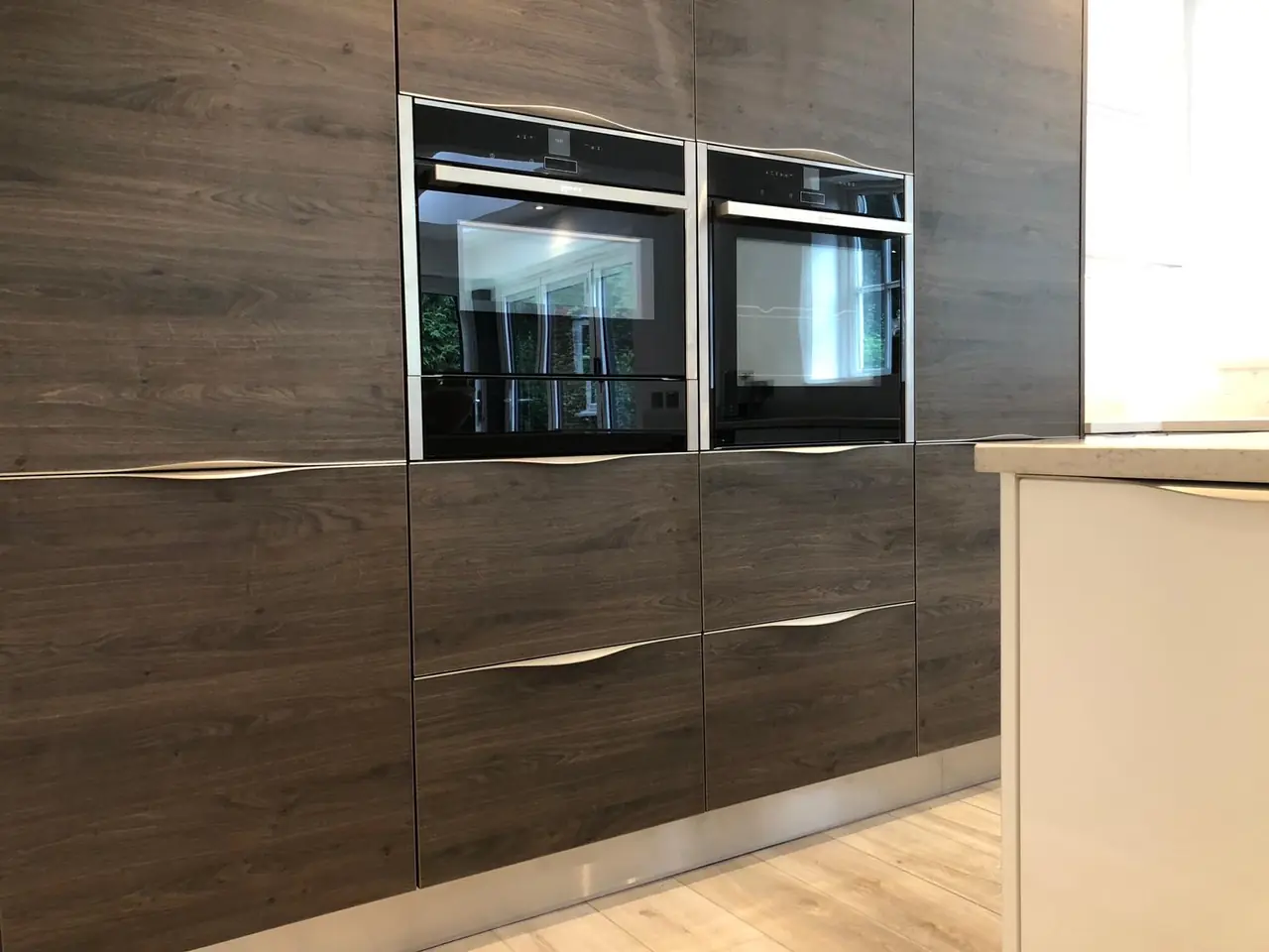 Kitchen dark wood double ovens close-up, made and fitted by Sussex Design Interiors