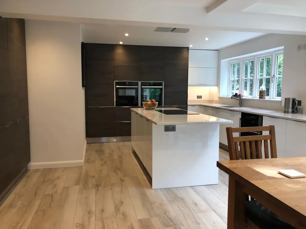 Kitchen dark wood white island dining chairs, made and fitted by Sussex Design Interiors