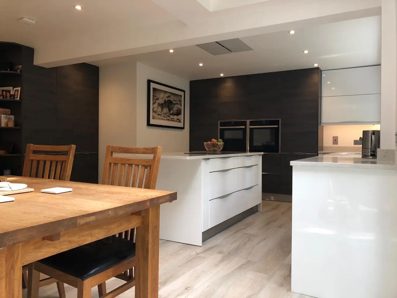 Kitchen dark wood white island dining table, made and fitted by Sussex Design Interiors