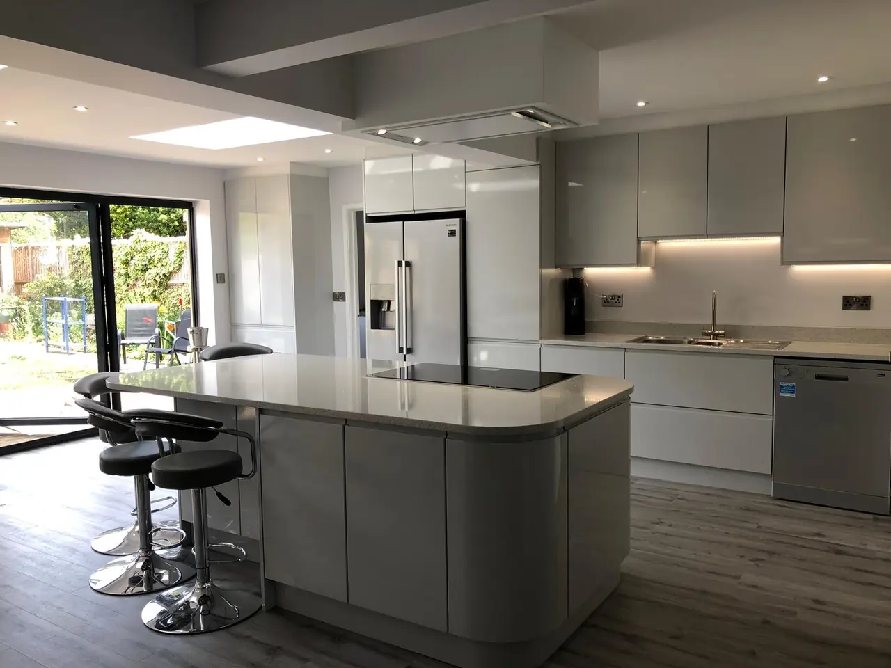 Kitchen grey gloss island bifold doors, made and fitted by Sussex Design Interiors