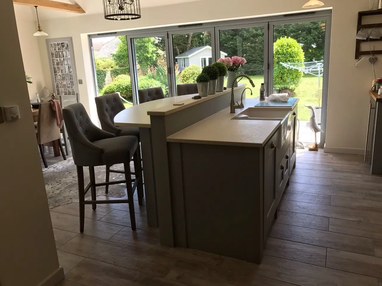 Kitchen island bar stools bifold garden view, made and fitted by Sussex Design Interiors