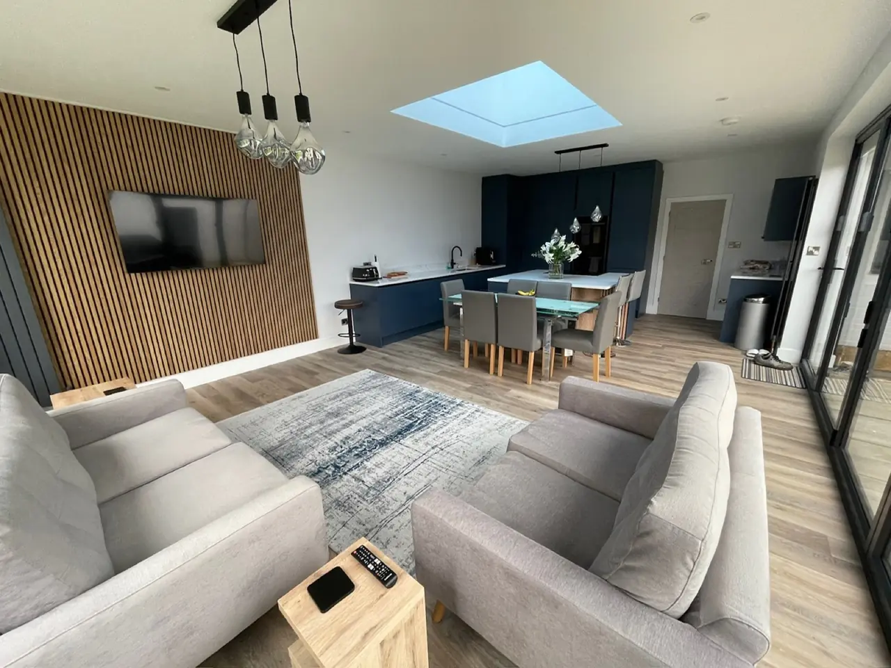 Kitchen navy blue slat wall TV living area, made and fitted by Sussex Design Interiors
