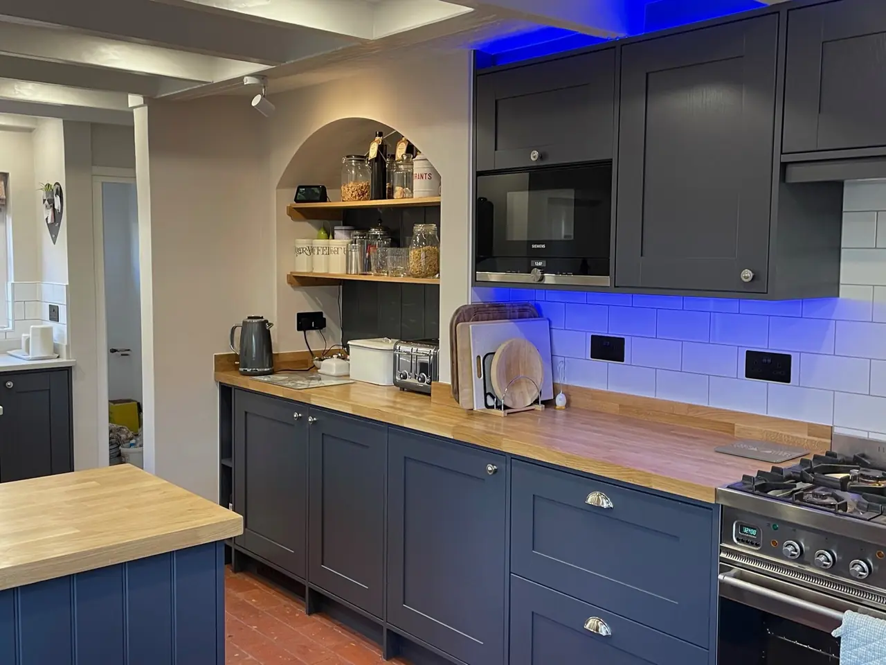 Kitchen navy shaker island oak top dining table, made and fitted by Sussex Design Interiors