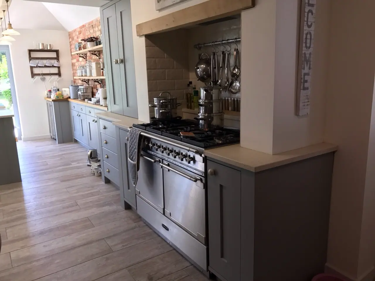 Grey shaker kitchen run with a large range cooker, made and fitted by Sussex Design Interiors