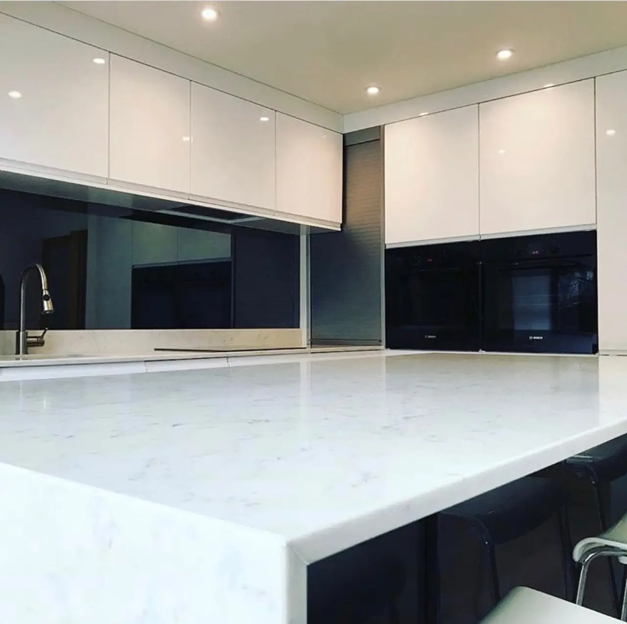 Kitchen white gloss black glass marble island close-up, made and fitted by Sussex Design Interiors