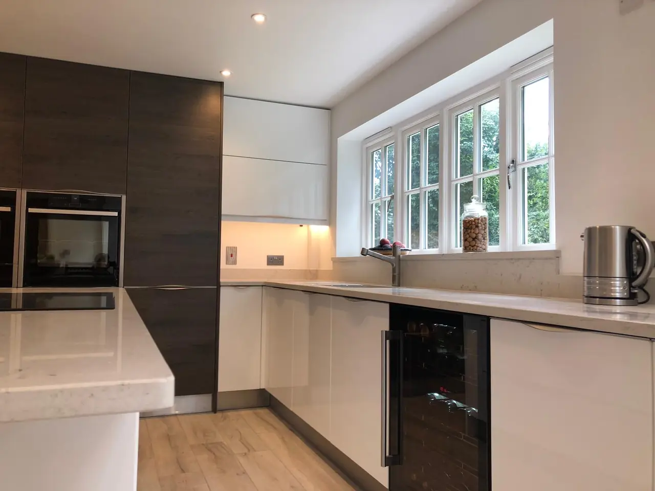 Kitchen white gloss dark wood wine cooler window, made and fitted by Sussex Design Interiors