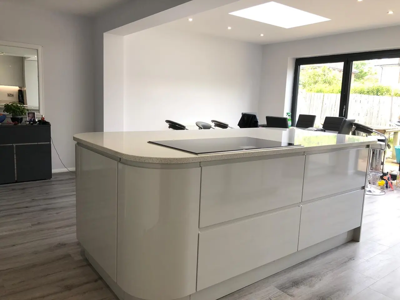 Kitchen white gloss island bifold doors, made and fitted by Sussex Design Interiors