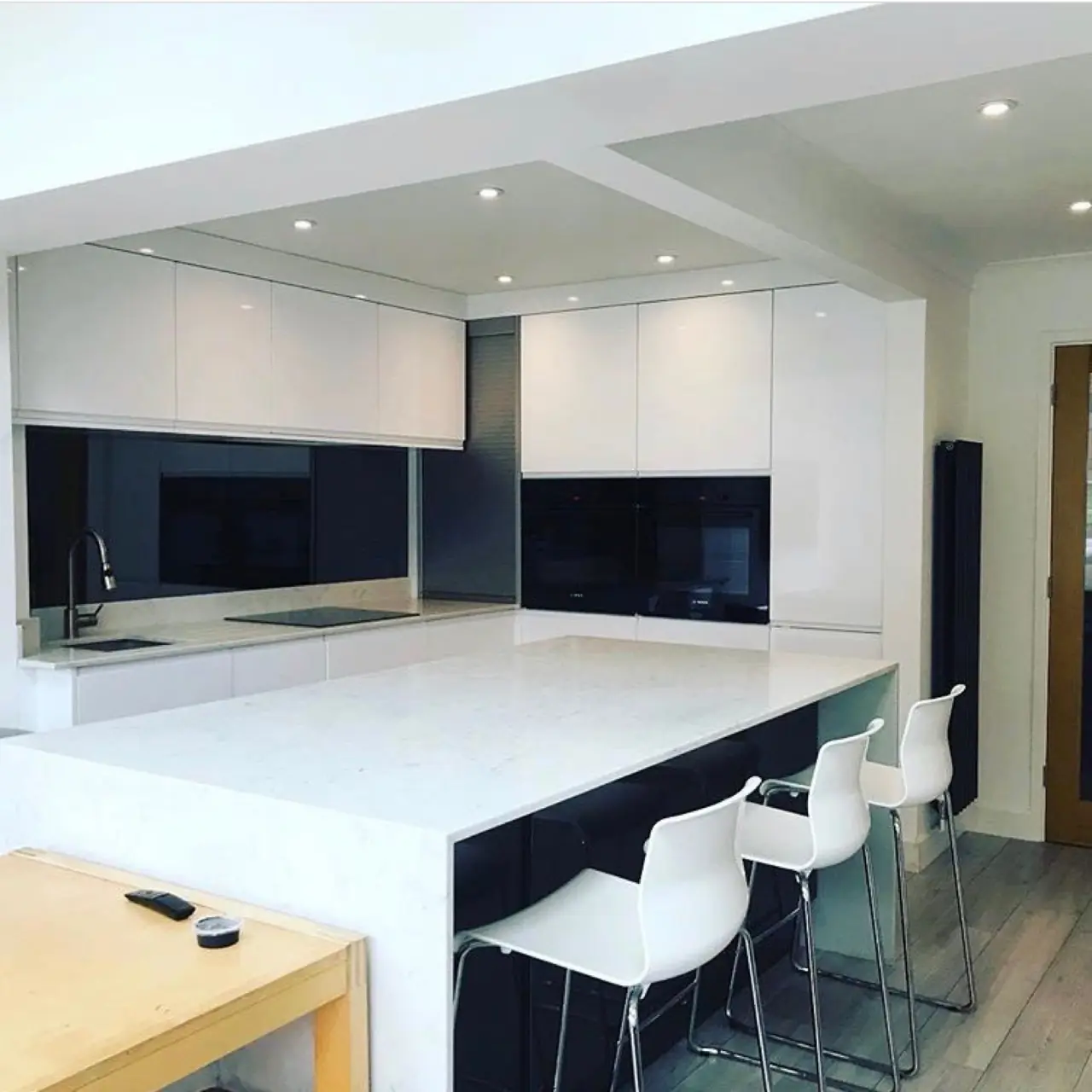 Kitchen white gloss navy island bar stools, made and fitted by Sussex Design Interiors