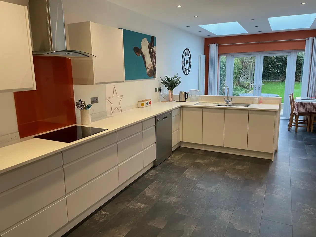 Kitchen white orange splashback skylight dining, made and fitted by Sussex Design Interiors