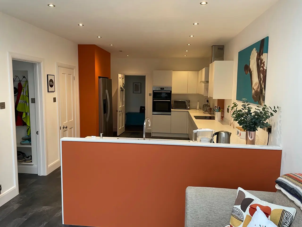 Kitchen white orange wall hallway view, made and fitted by Sussex Design Interiors