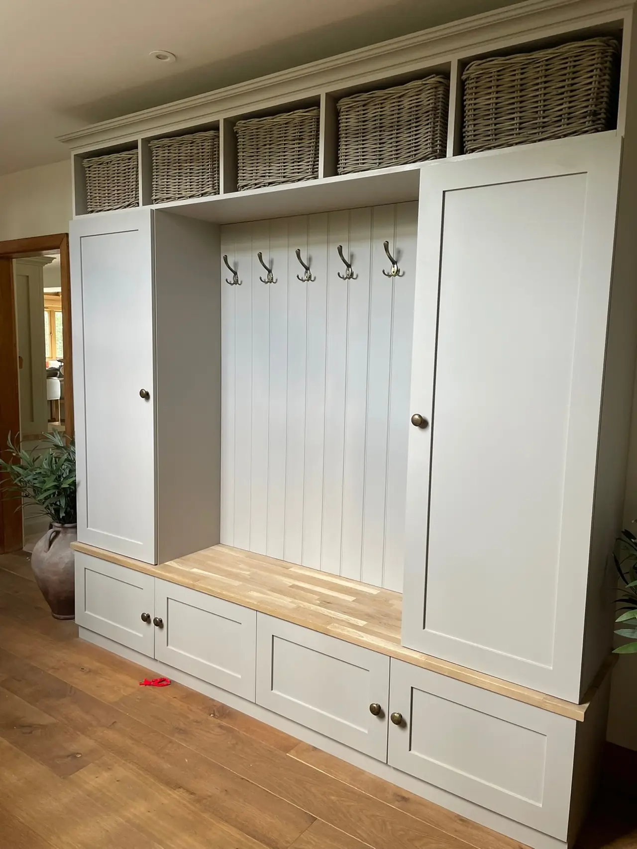 Mudroom bench hooks wicker baskets, made and fitted by Sussex Design Interiors