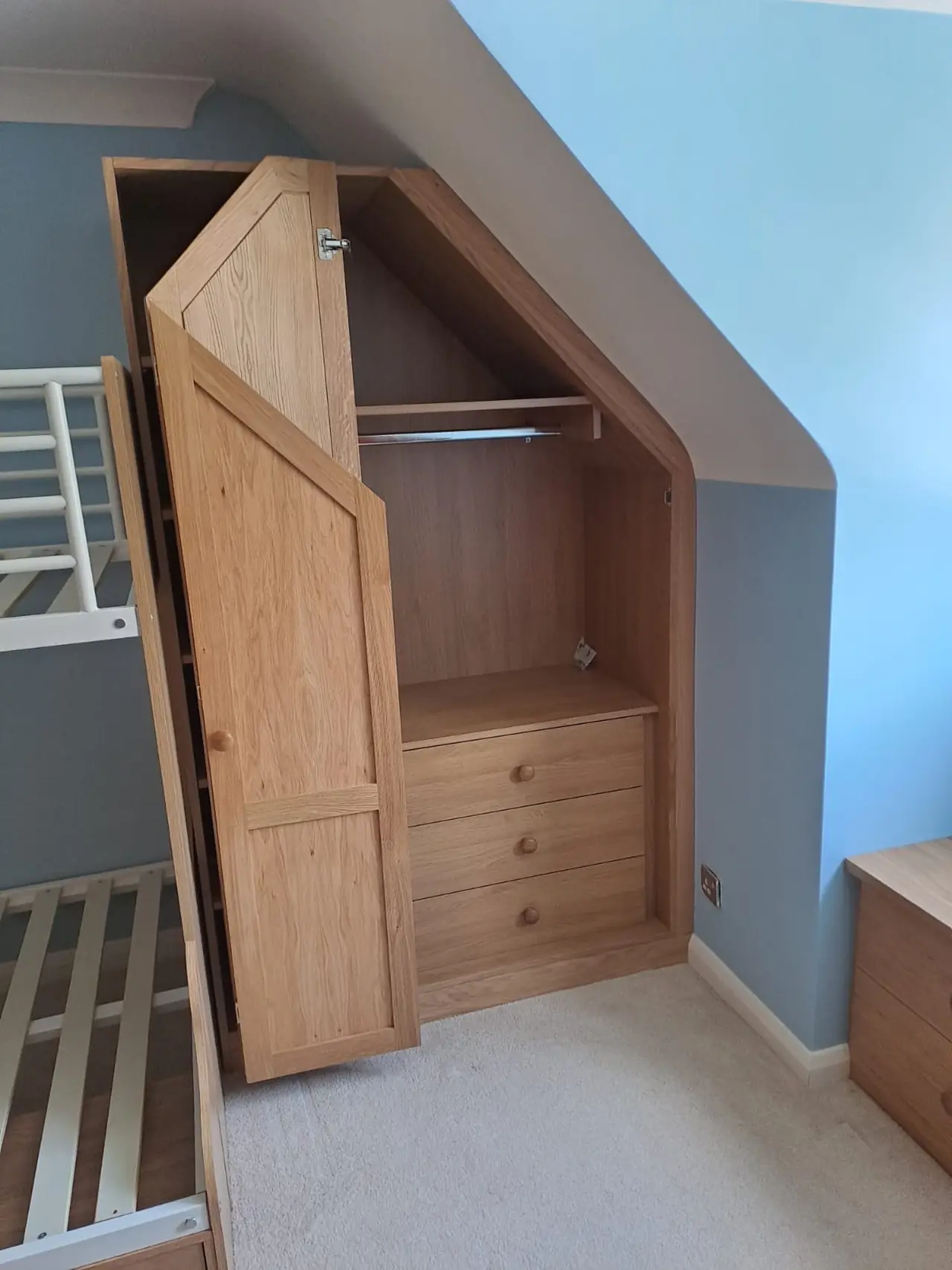 Oak wardrobe sloped ceiling bunk room, made and fitted by Sussex Design Interiors