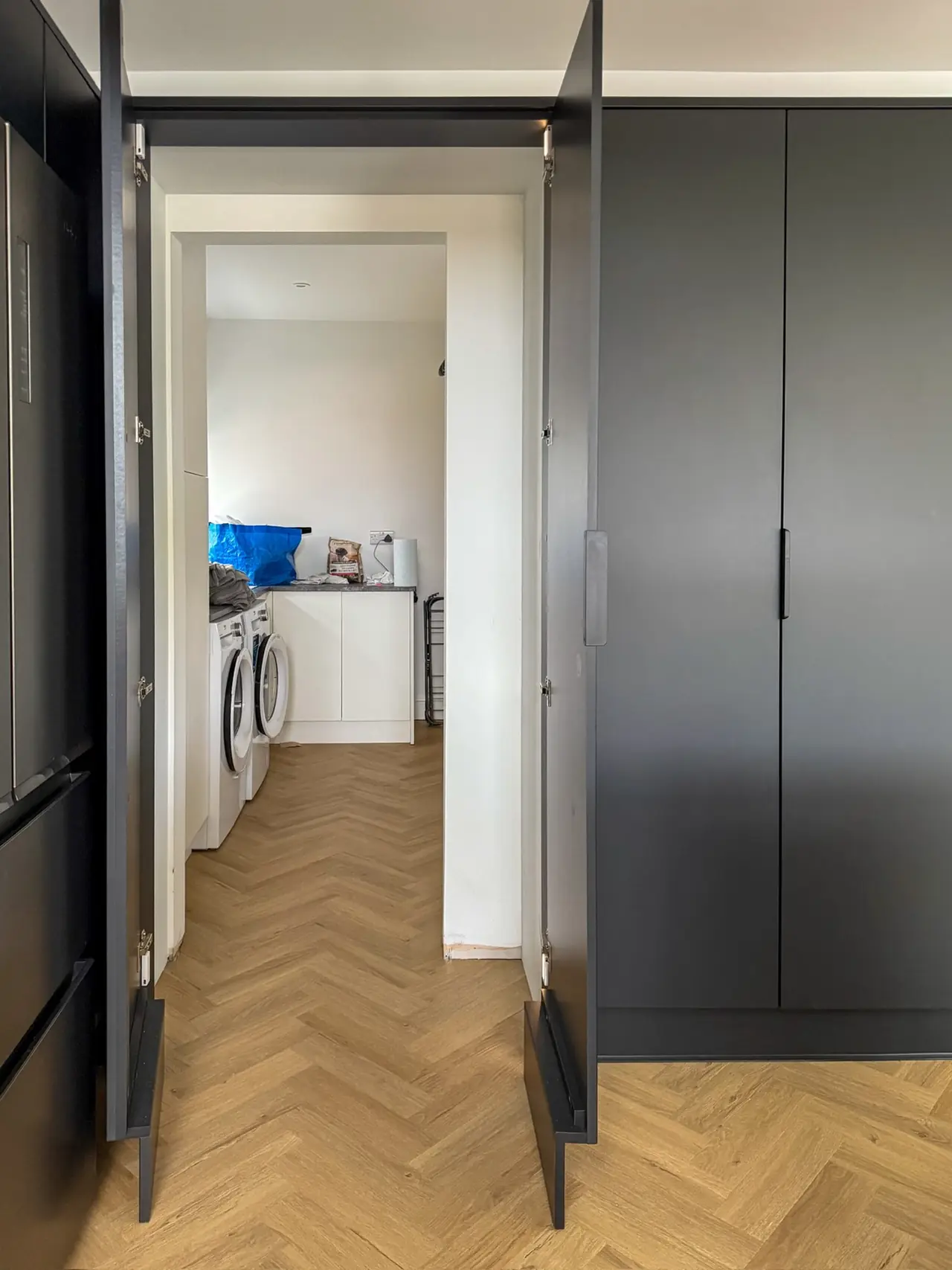 Utility room doorway dark grey tall units, made and fitted by Sussex Design Interiors