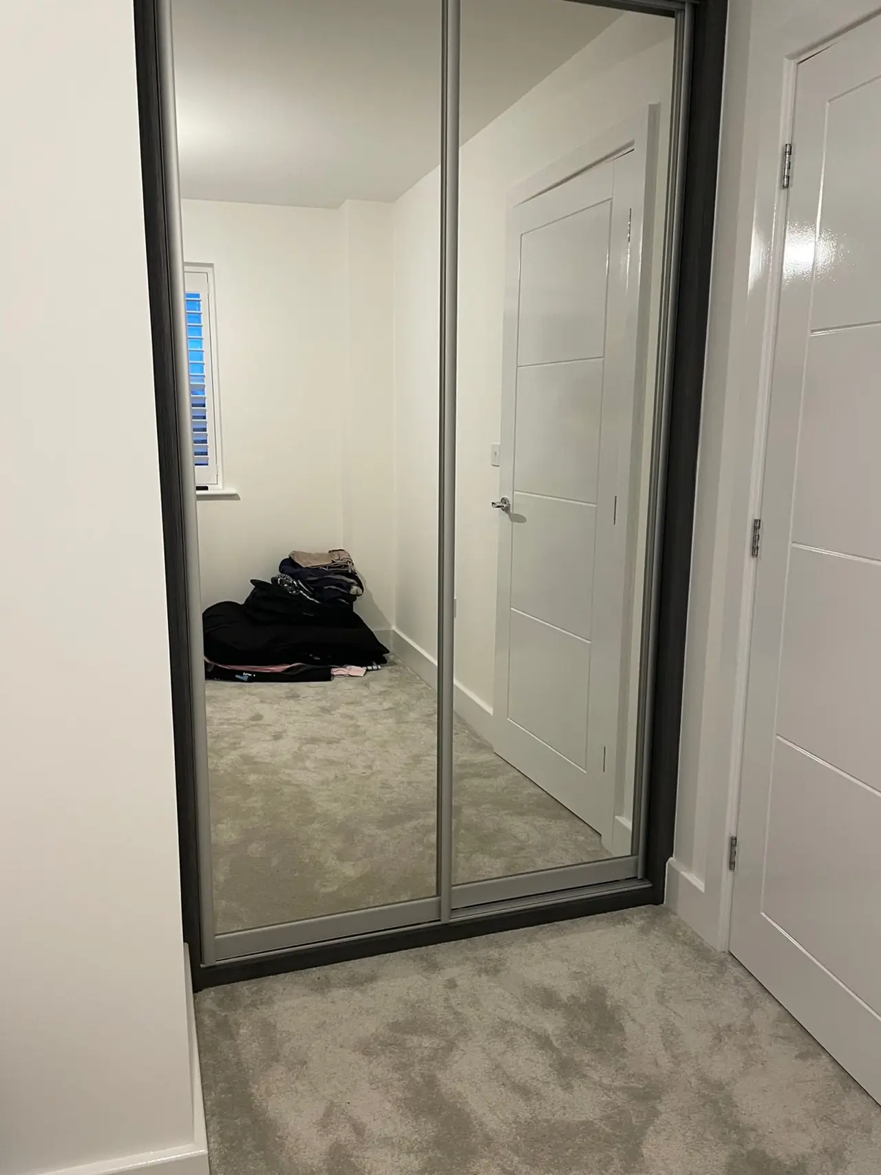 Wardrobe black frame mirror sliding door hallway, made and fitted by Sussex Design Interiors
