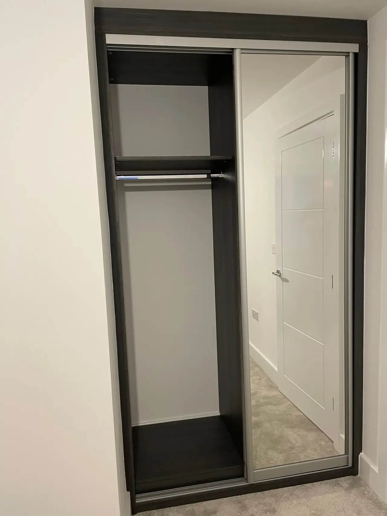 Wardrobe charcoal frame mirror sliding open shelves, made and fitted by Sussex Design Interiors