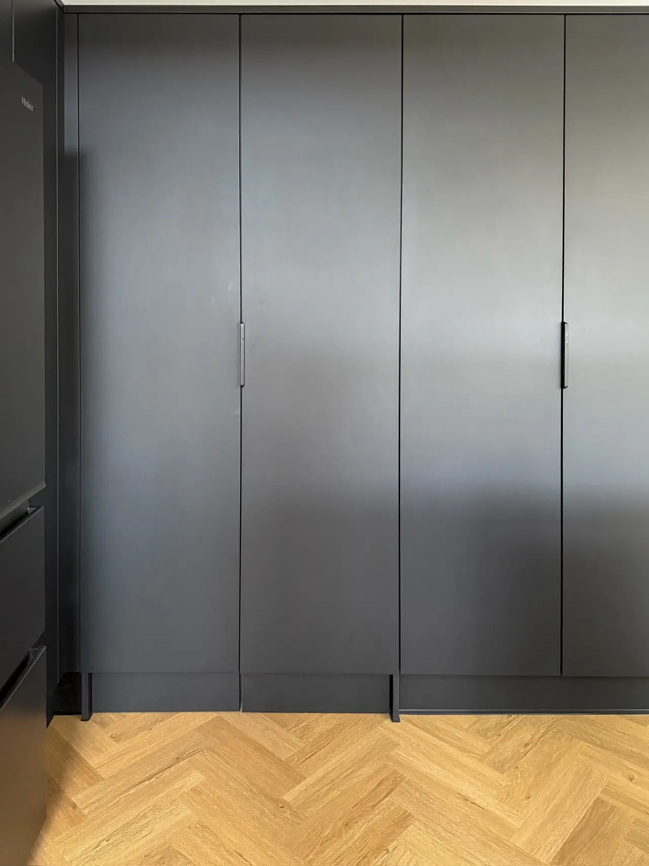 Wardrobe dark grey hinged doors herringbone floor, made and fitted by Sussex Design Interiors