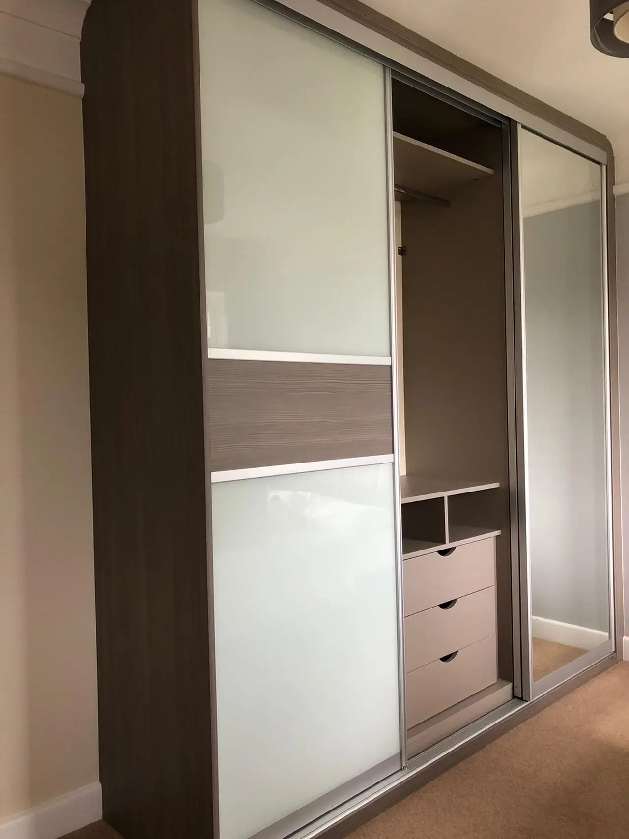 Full-height sliding wardrobe doors with mirrored glass panels